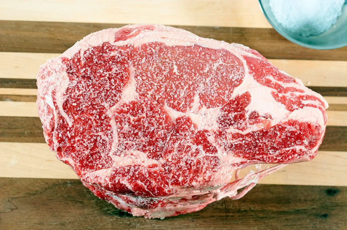25 Pitmaster Tips For Smoking A Prime Rib 7 Dry Brine prime rib on a cutting board.