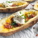 Loaded Potato Skins on wax paper.