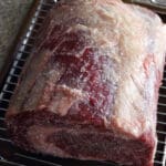 Close up prime rib on a baking sheet for how to dry brine prime rib article.