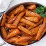 Silver baking dish of glazed carrots.