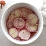 White bowl of pickled shallots.