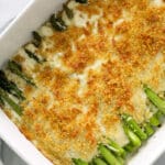 White pan full of cheesy asparagus casserole.