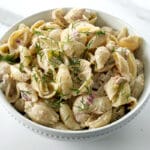 Bowl of tuna pasta salad with fresh dill.