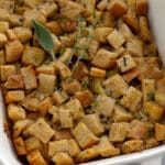Onion and sage stuffing in a white baking dish.