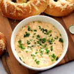 Bowl of Obatzda next to German soft pretzels.