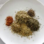 Plate of spices to make poultry seasoning.